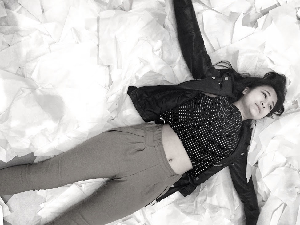 Marie lying on a pile of paper